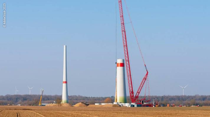 Construction of a wind turbine on a field.