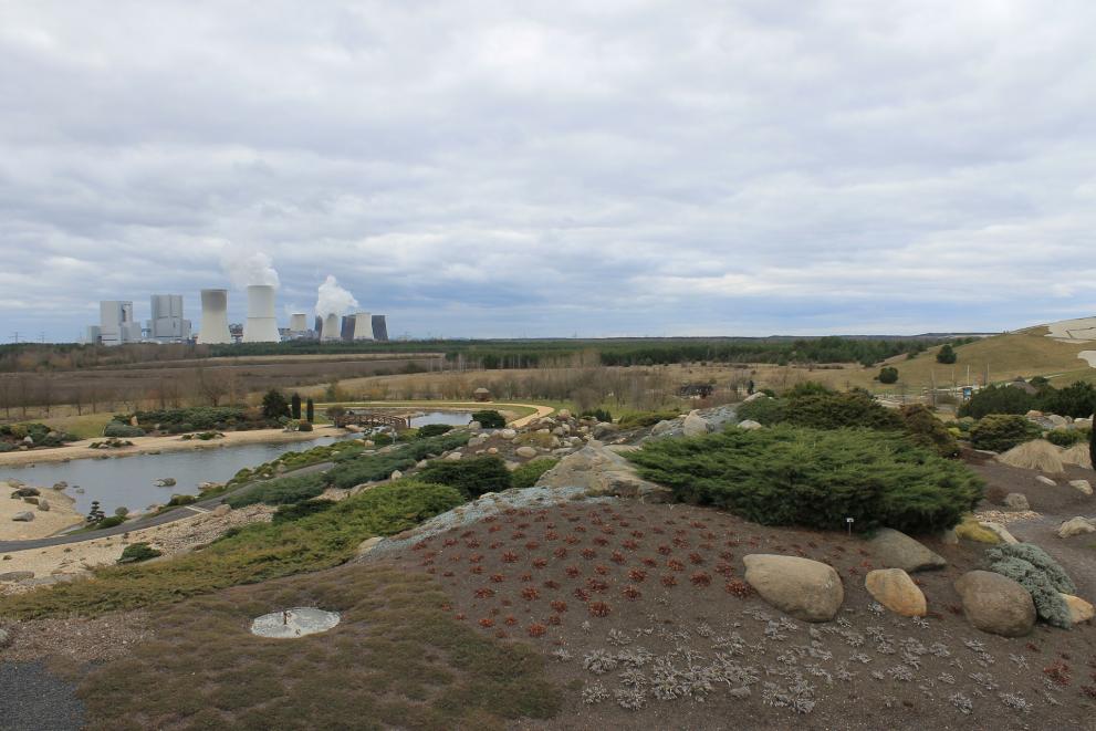 A landscape with a coal-fired power plant in the background