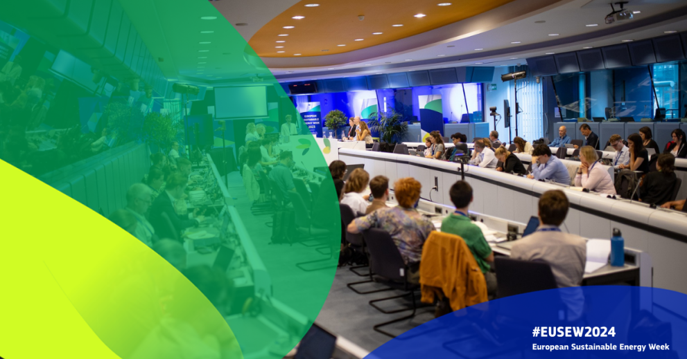 A photograph from a previous EU sustainable energy week shows a packed meeting room with 2 rows of participants on the left facing 2 rows of participants on the right 